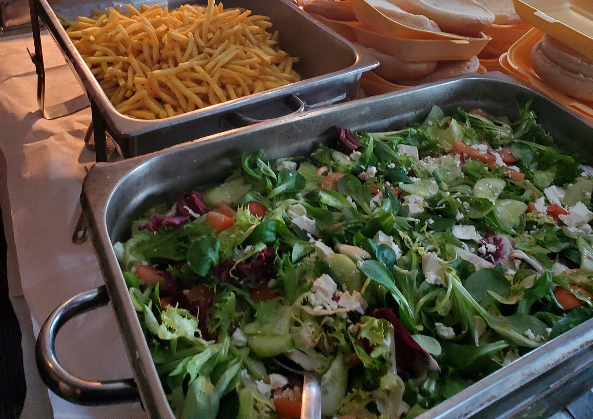 trays of salad and chips ready to be served