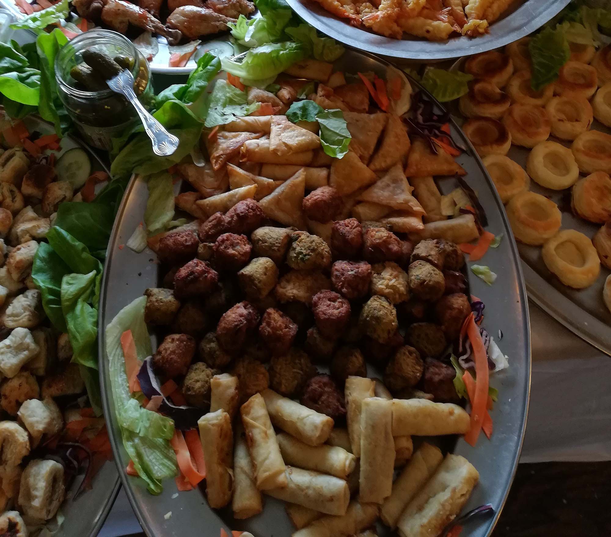 selection of meatballs and samosas for a catering event