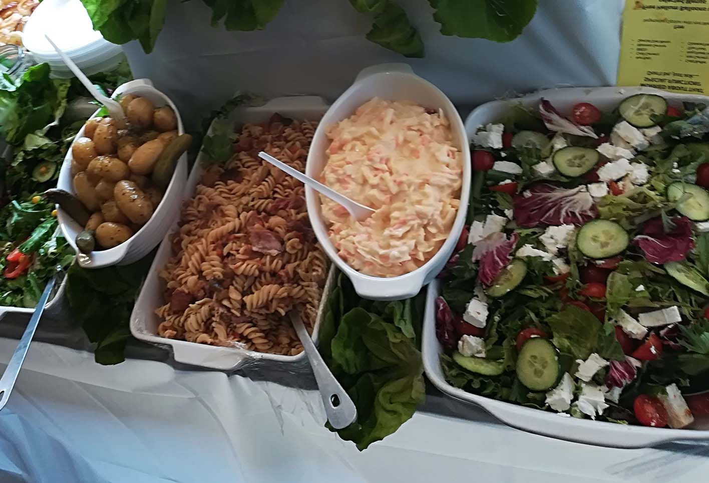 Potatoes, salad and pasta salad laid on a table