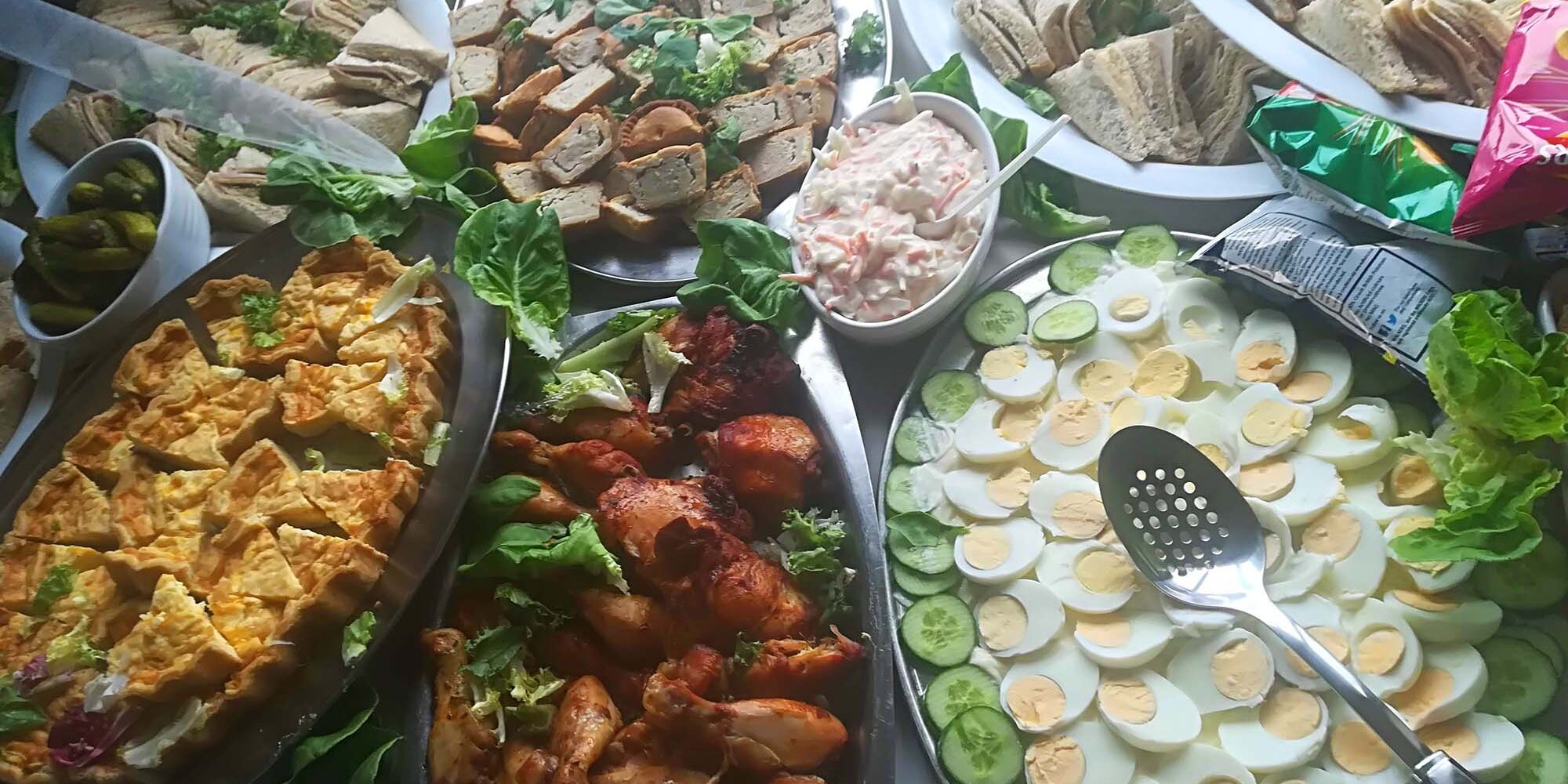 selection of pies, quiche and drumsticks at a catering event